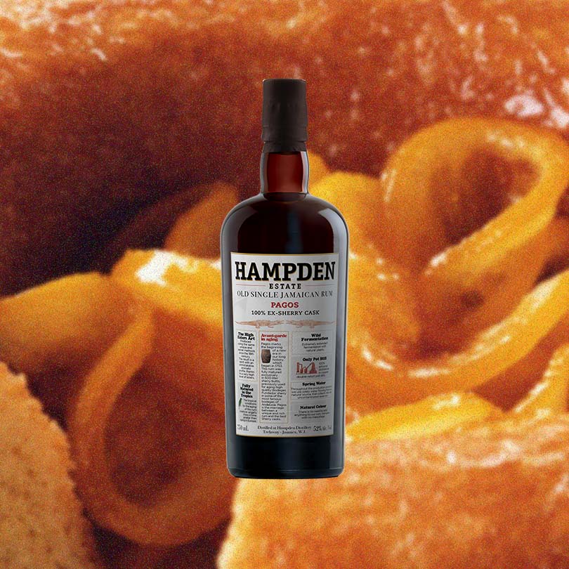 Bottle of Hampden Estate Pagos 100% Ex-Sherry Cask Rum over backdrop or orange gel like substance.
