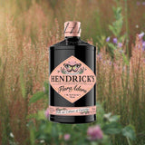 Bottle of Hendrick's Flora Adora Gin over background photo of flowers.
