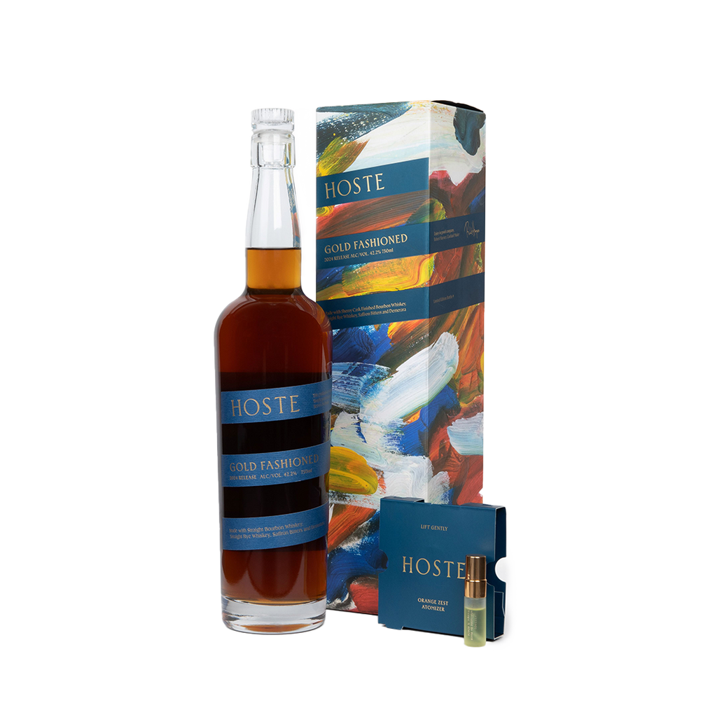 Bottle of Hoste Gold Fashioned and packaging, box it comes in, next to aromatizer.