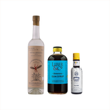 Bottles of La Puritita Verda Mezcal, Liber & Co Demerara Gum Syrup, and Angostura Aromatic Bitters.