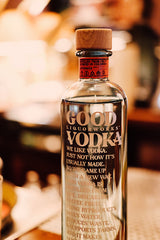 Bottle of Good Liquorworks Vodka on a blurred bar background
