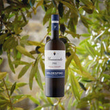 Bottle of Valdespino Inocente Fino Sherry over backdrop image of leaves.