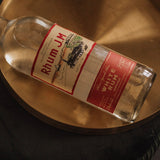 Bottle of Rhum JM White Rum on a metallic surface