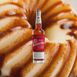 Bottle of Bottle of Kentucky Owl Takumi Edition over backdrop image of a pastry.
