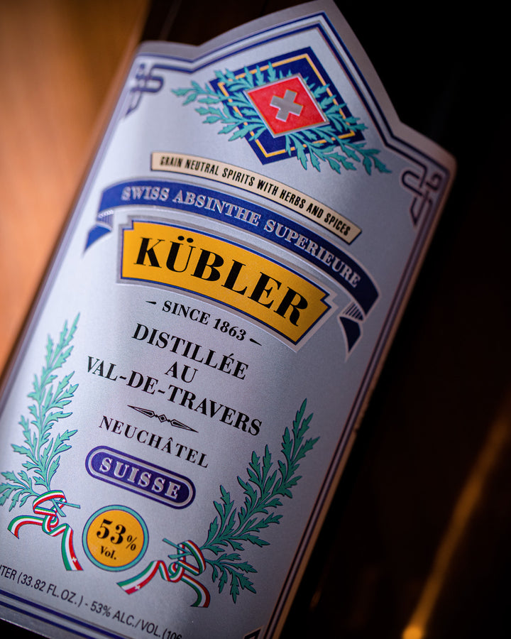 Close-up of a Kubler absinthe bottle label with detailed design and text.