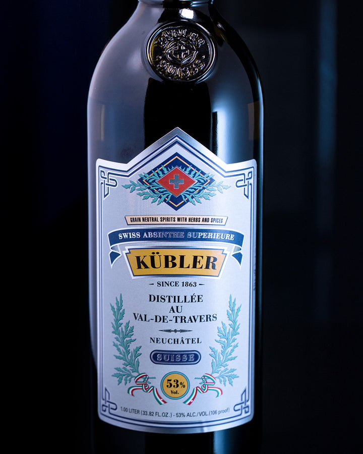 Kübler absinthe bottle with label on a dark background