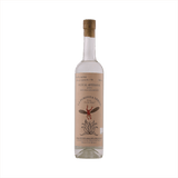 A tall thin bottle of mezcal with a craft paper label that reads: La Puritita Verda from Pierde Almas.  There's an illustration of a winged devil like creature diving into an agave plant.