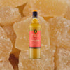 Bottle of Liber Fiergy Ginger Syrup on a textured ginger background.