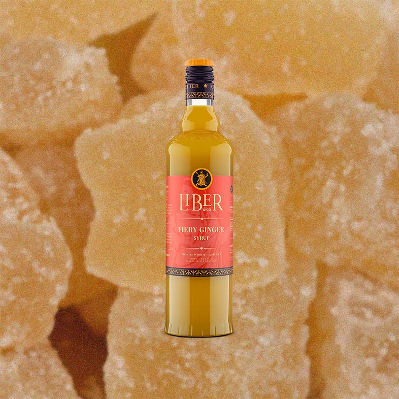 Bottle of Liber Fiergy Ginger Syrup on a textured ginger background.