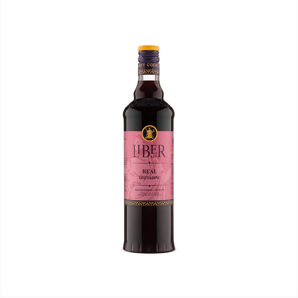 A bottle of Liber & Co. Real Grenadine with a pink label, showcasing the product's premium quality and pomegranate flavor.