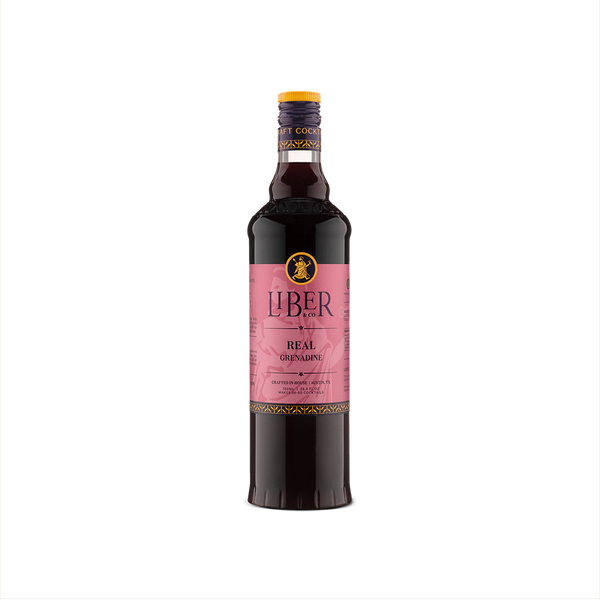 A bottle of Liber & Co. Real Grenadine with a pink label, showcasing the product's premium quality and pomegranate flavor.