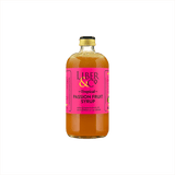 A large bottle of rich looking orange syrup with a fuschia label that reads: Liber & Co Tropical Passion Fruit Syrup.