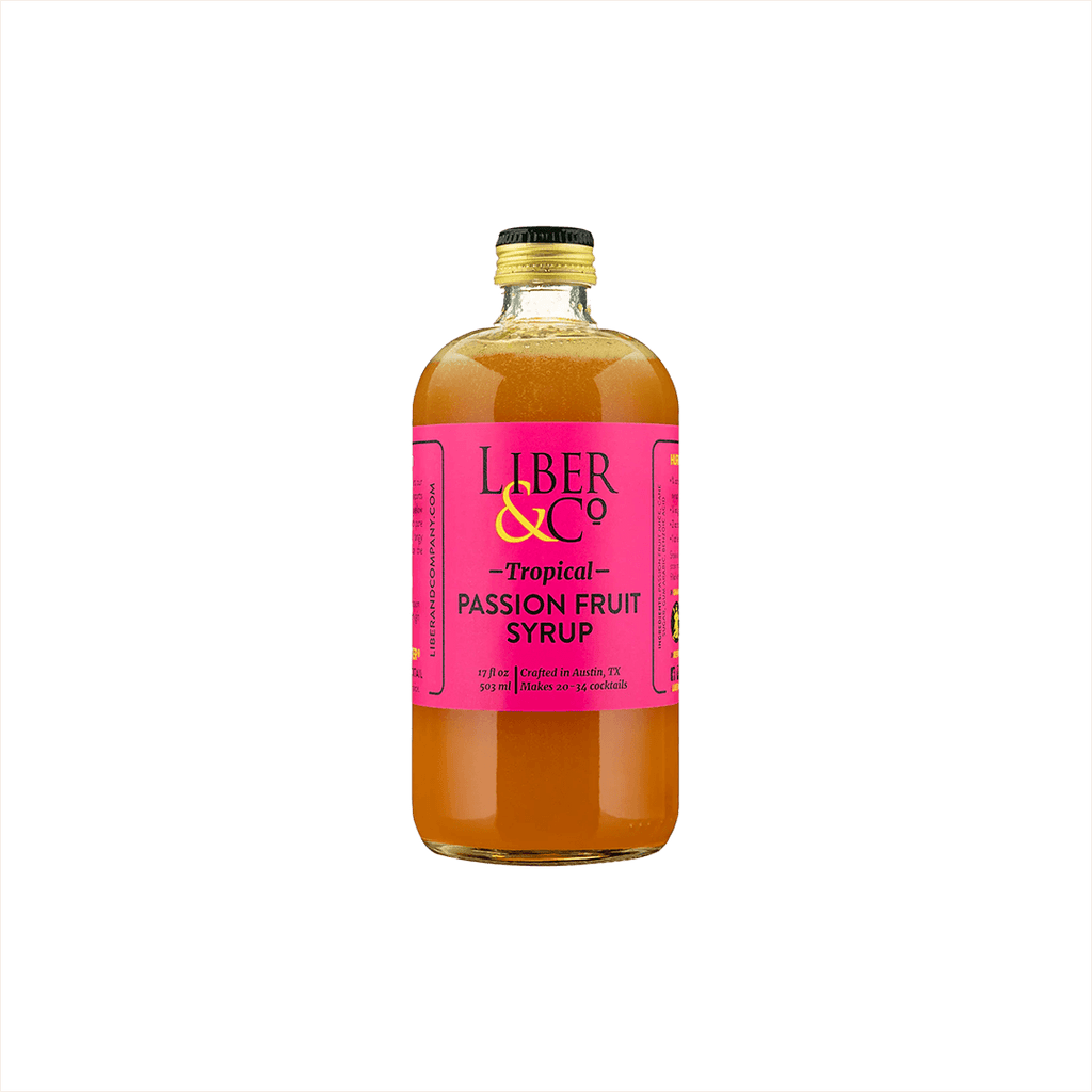 A large bottle of rich looking orange syrup with a fuschia label that reads: Liber & Co Tropical Passion Fruit Syrup.