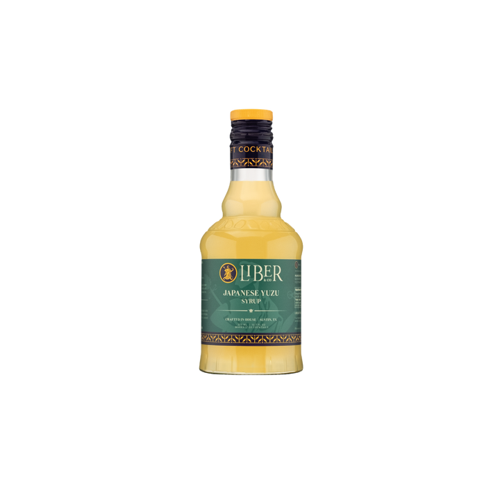 A bottle of Liber Japanese Yuzu Syrup with a green label and yellow liquid inside, set against a plain white background.