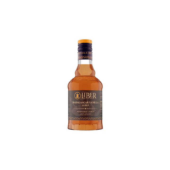 A bottle of Liber Madagascar Vanilla Syrup with amber-colored liquid, a dark brown label, and a gold cap, centered on a plain white background.