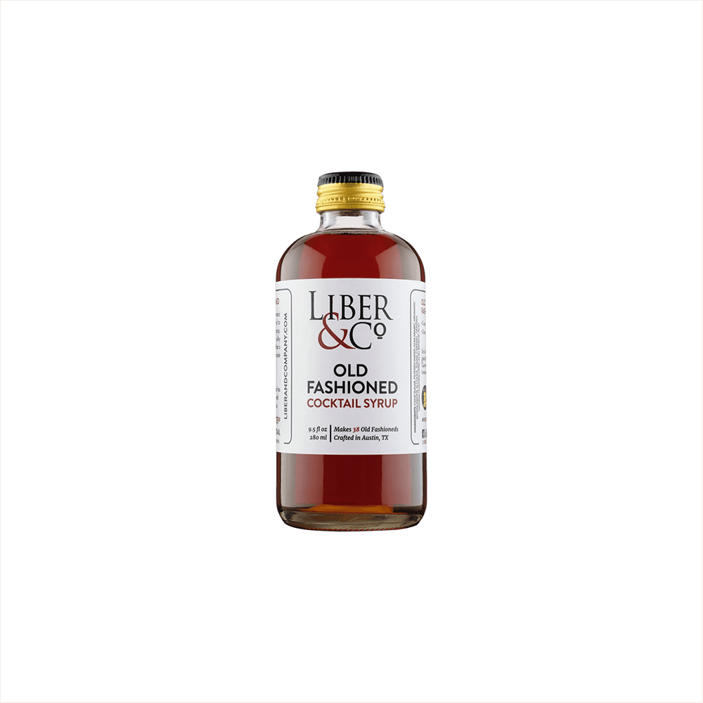 A small premium bottle of warm red liquid, the label reads: Liber & Co Old Fashioned Cocktail Syrup