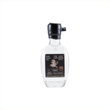 A mini sized 200ml bottle of The Lost Explorer Mezcal. The top is dipped in black wax, and the label is black with gold detailing.  It reads Mezcal Artesanal Hecho in Mexico.  10 Agave Age in Years.