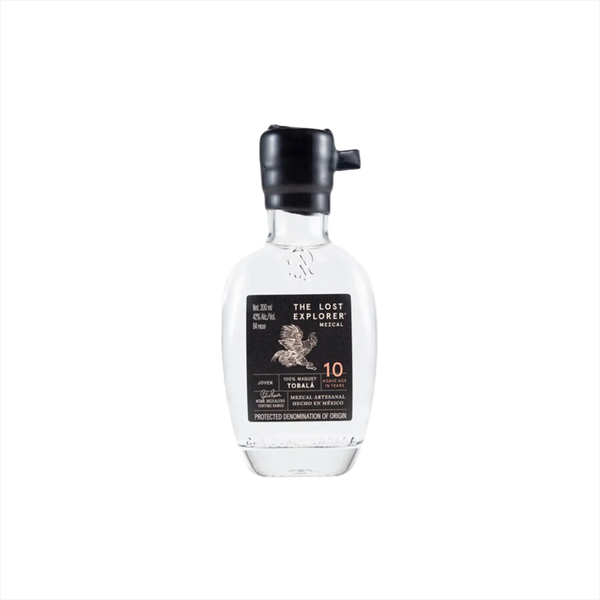 A mini sized 200ml bottle of The Lost Explorer Mezcal. The top is dipped in black wax, and the label is black with gold detailing.  It reads Mezcal Artesanal Hecho in Mexico.  10 Agave Age in Years.