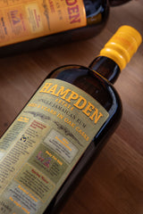 Hampden Estate rum bottle with label on a wooden surface