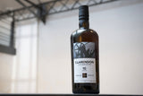 Whiskey bottle with 'Clarendon' label on a blurred background