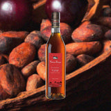 Bottle of Maison Rouge V.S.O.P. Cognac over backdrop image of almonds and cherries.
