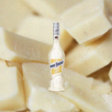 Bottle of Marie Brizard Crème de Cacao White over backdrop image of blocks of white cheese.