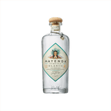A premium bottle of clear tequila with a wood stopper. The label is diamond shaped with a teal edge, and it reads: Mayenda Tequila Blanco. 100% Agave Azul.
