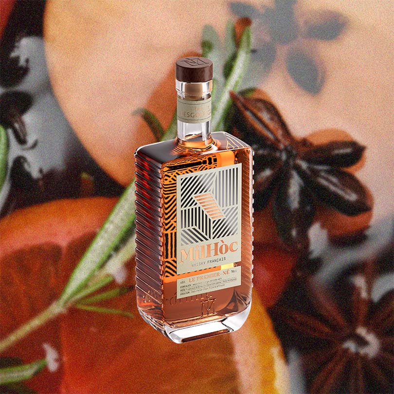 Bottle of Milhoc liquor with pumpkins and star anise in the background