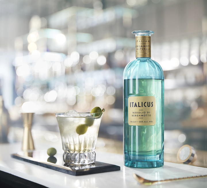 Bottle of Italicus gin with a cocktail on a bar counter