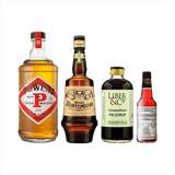 Bottles of Powers Gold Label Irish Whiskey, Amaro Montenegro, Liber & Co. Caramelized Fig Syrup, and Peychauds Bitters.