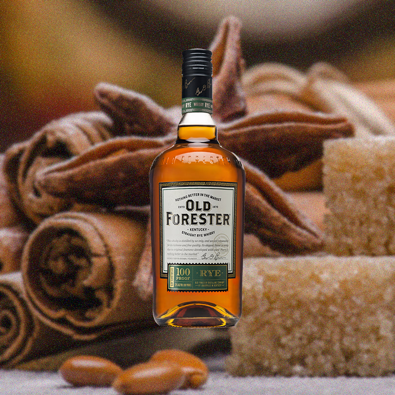 Bottle of Old Forester Rye against a backdrop of sugar cubes, star anise, cinnamon and other baking spices.