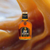 A bottle of Old Granddad 114 against a backdrop of delicious swirling caramel.
