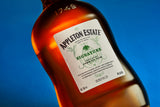 Bottle of Appleton Estate rum against a blue background