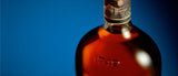 Bottle of Appleton rum with a blue background.