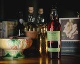 Bottle of Probitas rum on a table with other bottles and decor in the background