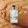 Bottle of Palm Republic Silver Rum over backdrop image of a cookie up close. 