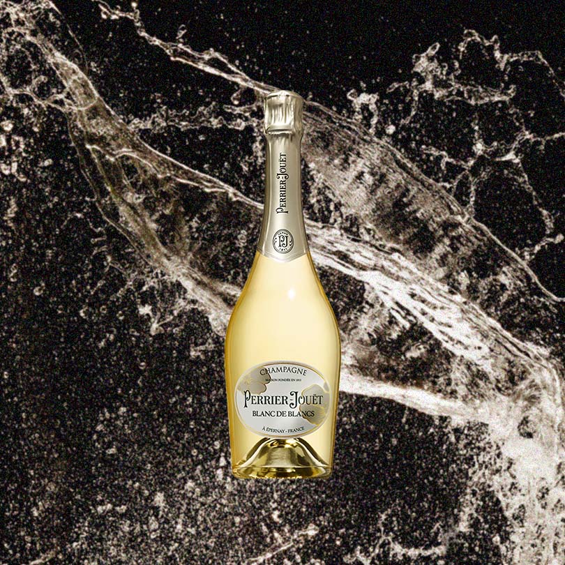 Bottle of Perrier Jouet Blanc De Blancs Champagne over back drop image of champagne flying into the air!