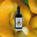 Bottle of Bottle of Dansk Mjod Philosopher's Stone Viking Shrub Citrus Edition over backdrop image of orange peels.