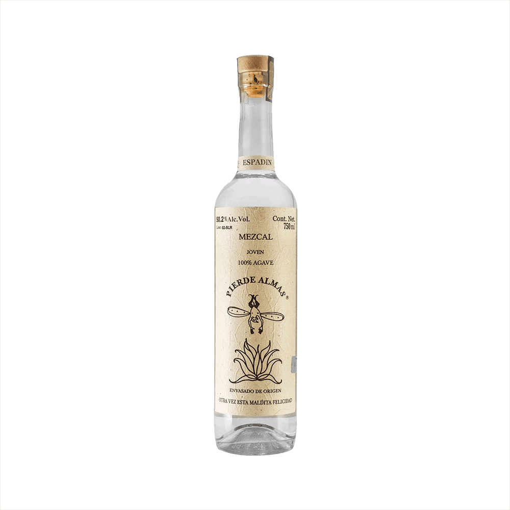 A tall thin bottle of mezcal with a craft paper label that reads: Mezcal Joven 100% Agave Pierde Almas. There is an simple illustration of a devil like character with wings diving blissfully into an agave plant.