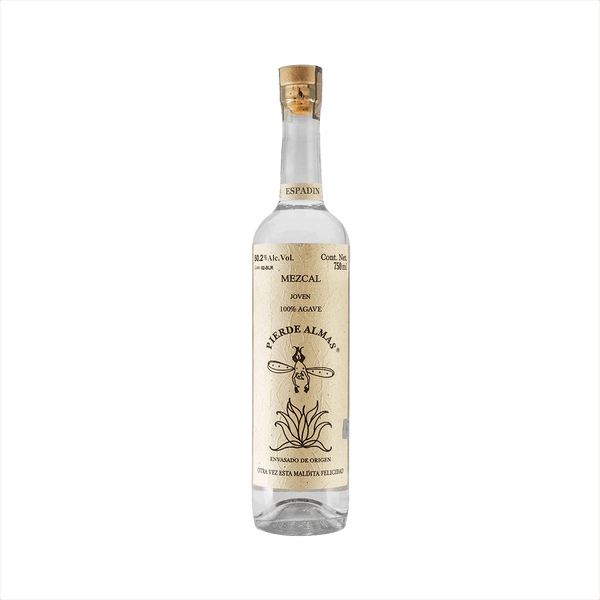 A tall thin bottle of mezcal with a craft paper label that reads: Mezcal Joven 100% Agave Pierde Almas. There is an simple illustration of a devil like character with wings diving blissfully into an agave plant.