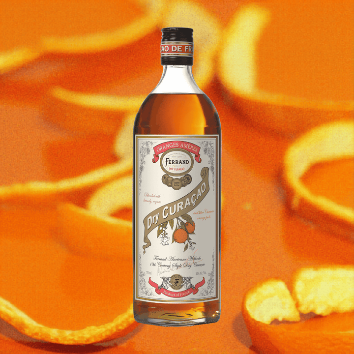 Bottle of Ferrand Dry Curacao liqueur with orange peels in the background