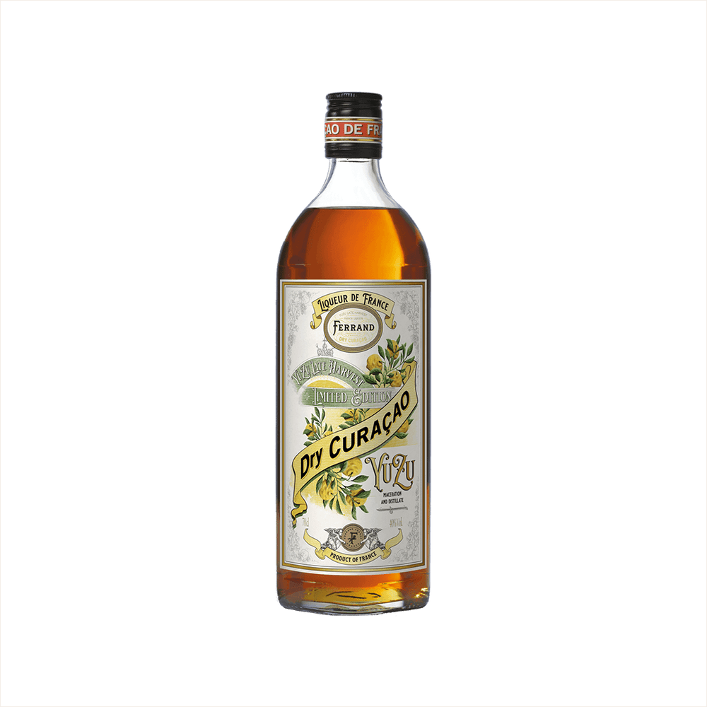 A bottle of yellow liqueur, with an ornate label. It reads Pierre Ferrand Dry Curacao Yuzu. There is a banner above that reads: Yuzu Late Harvest Limited Edition.