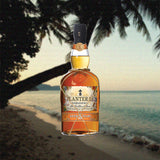 Bottle of Planteray 5 Year Rum over backdrop image of a beach.