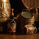 Two bottles of Planteray Mister Fogg Rum on a table next to some nautical items.
