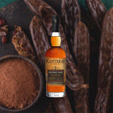 Bottle of Planteray Original Dark Barbados Jamaica Rum - formerly Plantation - against a backdrop of dried tobacco and cocoa powder.