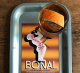 Bonal tonic water advertisement with a glass of tonic and orange on a tray.