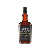 A bottle of amber colored liquid with The Real McCoy Single Blended Rum Aged 12 Years on the label.  Foursequare Distillery, St. Philip, Barbados, at the bottom.