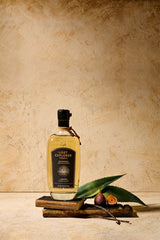 Bottle of The Lost Explorer Reposado Tequila in front of a tan wall backdrop.