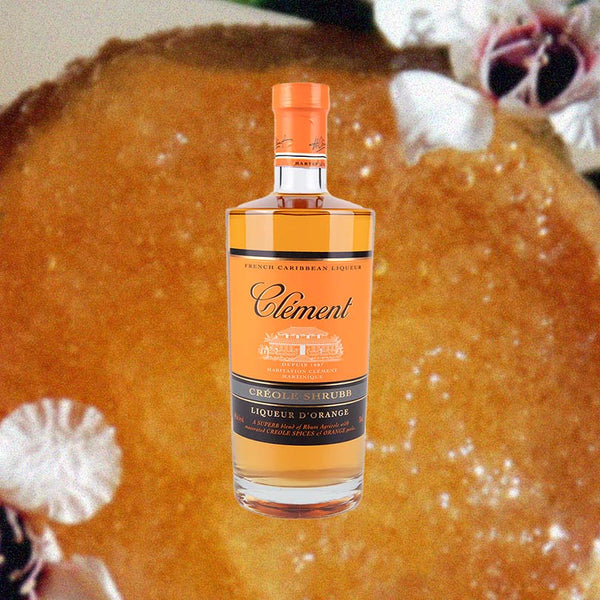 Bottle Rhum Clement Creole Shrubb over backdrop image of unidentifiable orange gel substance.