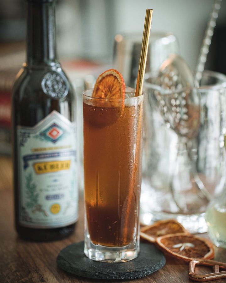 Glass of iced tea with a bottle of syrup in the background